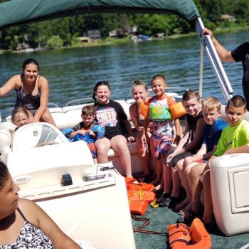 A group of individuals wearing life jackets aboard a boat