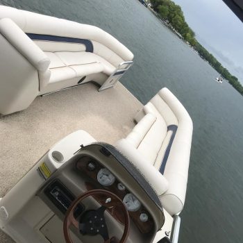 A driver's perspective from the helm of a boat, showcasing the water ahead and the horizon in the distance.