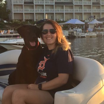 A woman and her dog enjoy a peaceful moment together on a boat