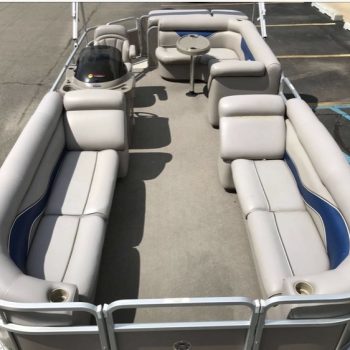 A pontoon boat featuring comfortable seating and a central console for navigation and control.