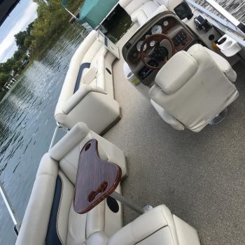 A sleek boat featuring a white leather interior and a polished steering wheel