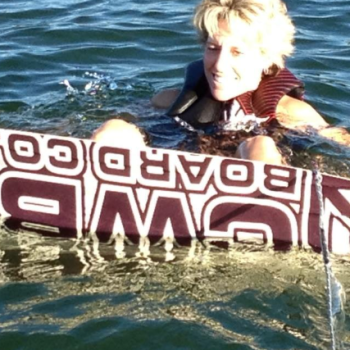 A woman gracefully water skiing on a clear lake